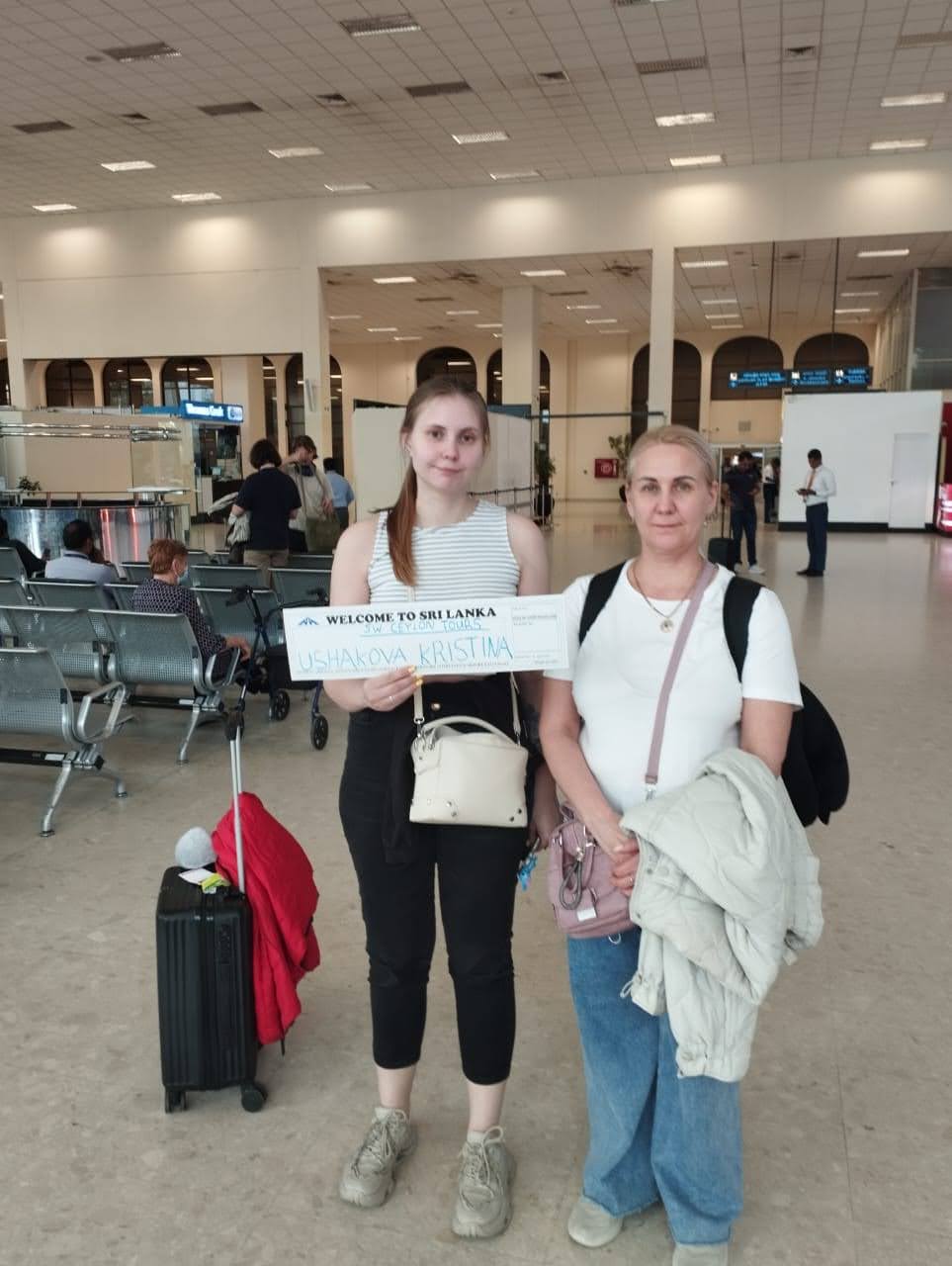 Ushakova family — warm BIA airport welcome with our SW Ceylon Tours sign