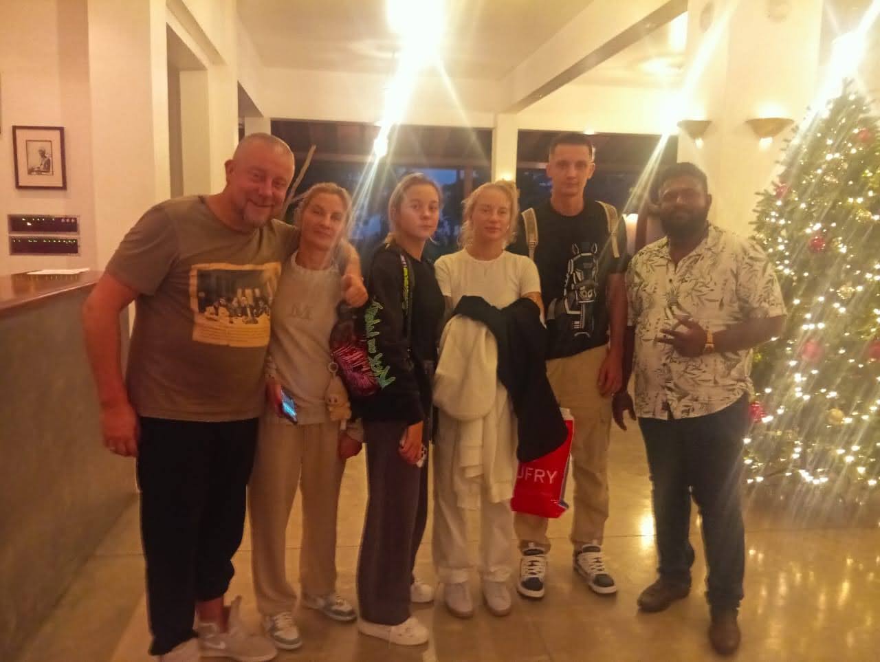 Festive evening at the hotel — group photo by the Christmas tree