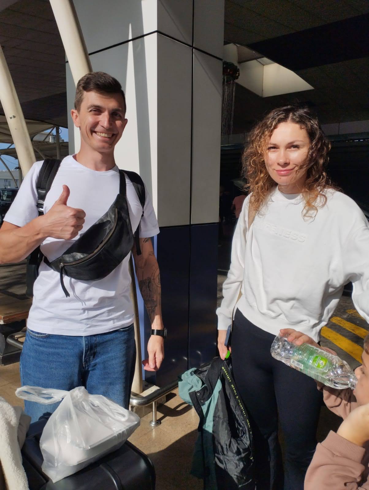 Couple landing in Sri Lanka — bright smiles outside the terminal