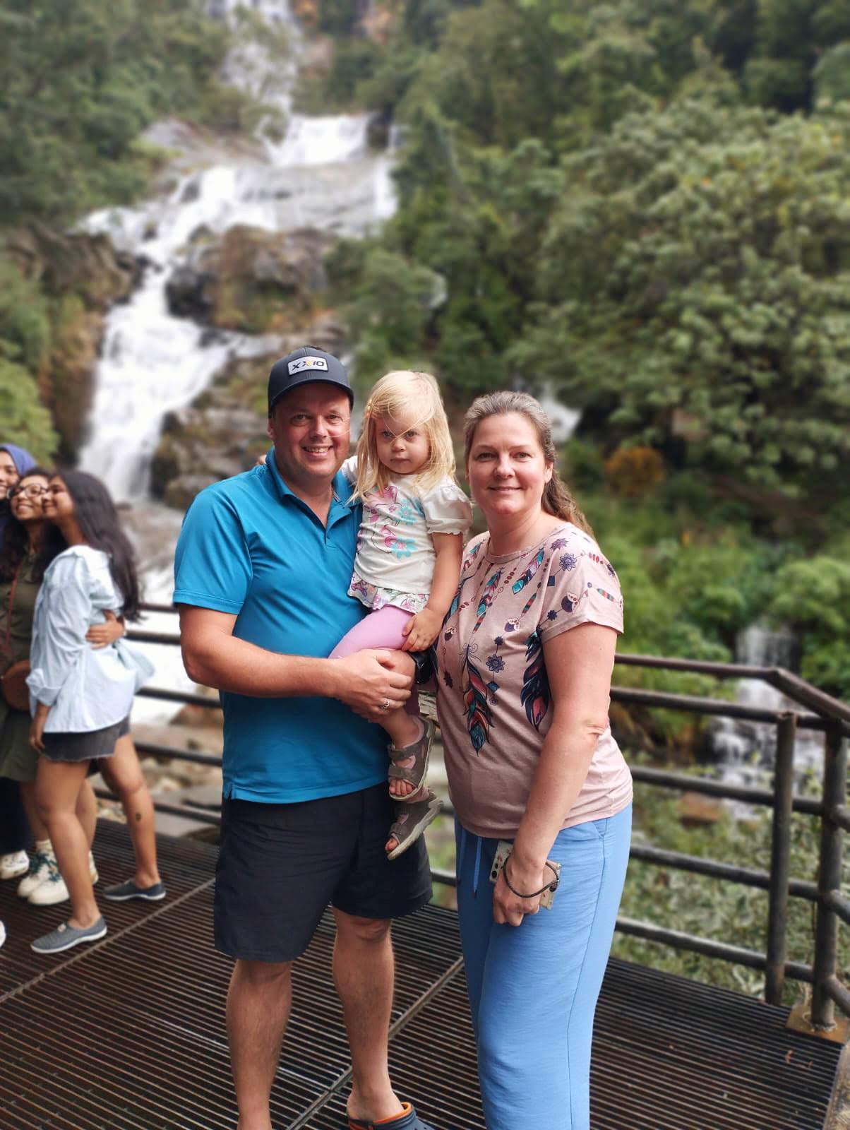 Family moment at a hill-country waterfall