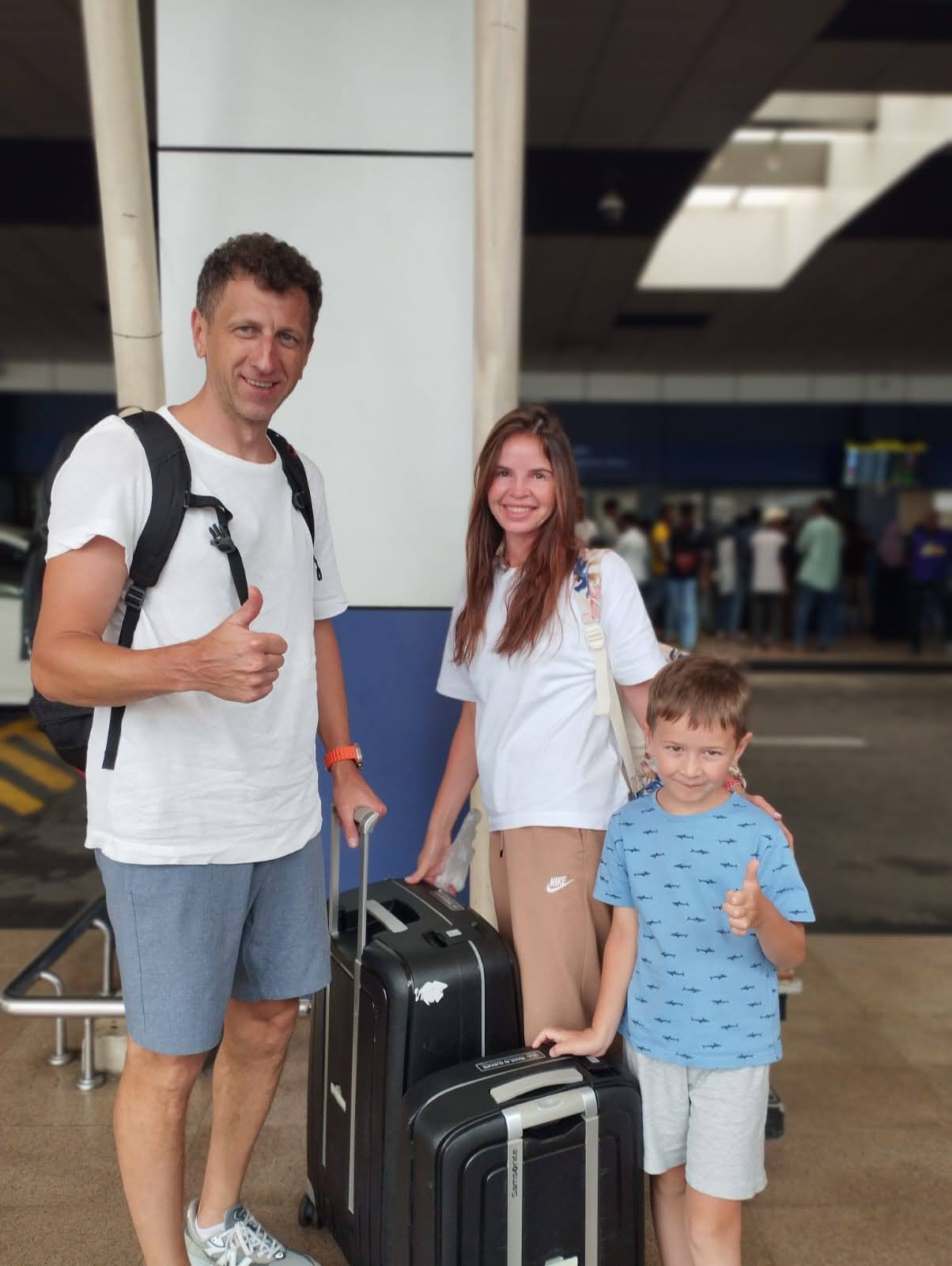 Happy family arrival — thumbs up from our youngest traveler